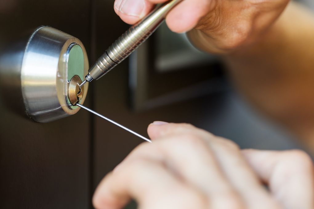 Locksmith opening a deadbolt with professional tools